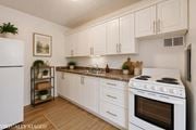 Hamilton apartment for rent - A kitchen with white cabinets and a white stove top oven.