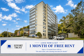 Hamilton apartment for rent - A tall building with a sign offering 1 month of free rent.