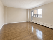 Hamilton apartment for rent - Empty room with wooden floors and a window.