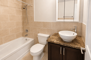 Hamilton apartment for rent - A bathroom with a white toilet, sink, and bathtub.