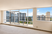 Hamilton apartment for rent - A room with a large window overlooking a cityscape.