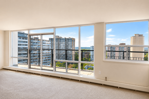 Hamilton apartment for rent - A room with a large window overlooking a cityscape.