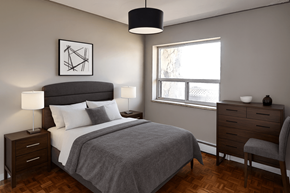 Hamilton apartment for rent - A bedroom with a large bed, a nightstand, and a chair.