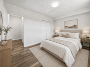 Hamilton apartment for rent - A bedroom with a large bed and a wooden dresser.