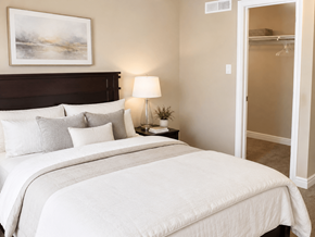 Hamilton apartment for rent - A bedroom with a large bed and a painting on the wall.