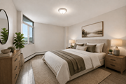 Hamilton apartment for rent - A bedroom with a large bed, a mirror, and a painting on the wall.