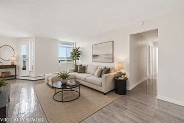 Hamilton apartment for rent - A living room with a white couch and a coffee table.