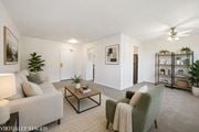 Hamilton apartment for rent - A living room with a grey couch, a green armchair, and a coffee table.