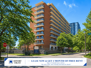 Hamilton apartment for rent - A large brick building with a sign offering a free month of rent for a 13-month lease.