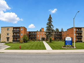 Hamilton apartment for rent - A large brick building with a sign that says