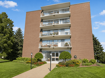 Dundas apartment for rent - A red brick building with a balcony on the second floor.