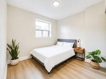 Hamilton apartment for rent - A bedroom with a white bed and a window.