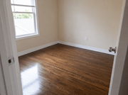 Cobourg apartment for rent - A room with wooden flooring and a window letting in natural light.