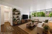 Hamilton apartment for rent - A living room with a couch, a coffee table, and a television.