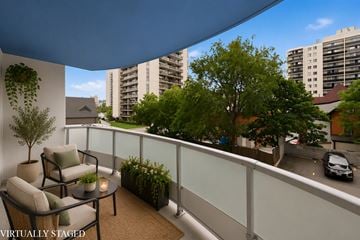 Hamilton apartment for rent - A balcony with a table and chairs overlooking a street.