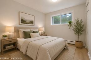 Hamilton apartment for rent - A bedroom with a large bed and a painting on the wall.