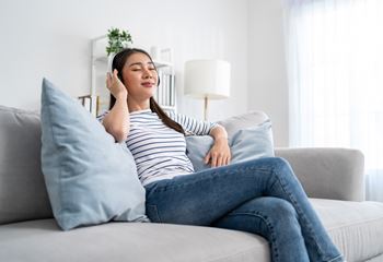 A woman is sitting on a couch 