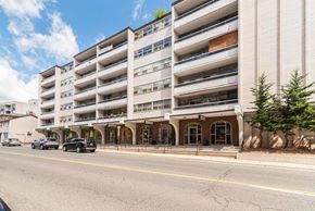 Dundas apartment for rent - A large white building with a green sign on the top left corner.