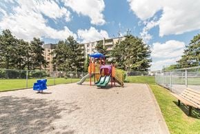 Hamilton apartment for rent - A playground with a slide, swings, and a sandbox.