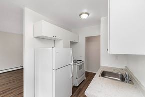 Hamilton apartment for rent - A kitchen with white appliances and a sink.