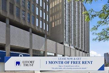 Hamilton apartment for rent - A large building with a sign offering a free month of rent.