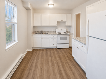 Hamilton apartment for rent - A kitchen with white appliances and cabinets.