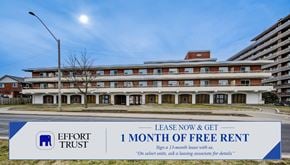 Hamilton apartment for rent - A large building with a sign offering a free month of rent.