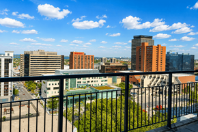 Hamilton apartment for rent - A cityscape with buildings of various heights and a clear blue sky.