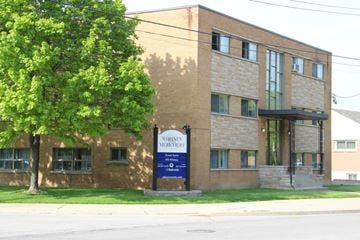 Hamilton apartment for rent - A brick building with a sign that says Whiskey Mercure.