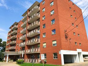 Hamilton apartment for rent - A red brick apartment building with a white garage door.