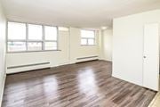Kitchener apartment for rent - A room with wooden floors and white walls.