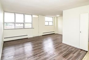 Kitchener apartment for rent - A room with wooden floors and white walls.
