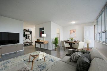 Hamilton apartment for rent - A living room with a grey couch and a glass coffee table.