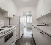 Hamilton apartment for rent - A kitchen with white cabinets and a stove top oven.
