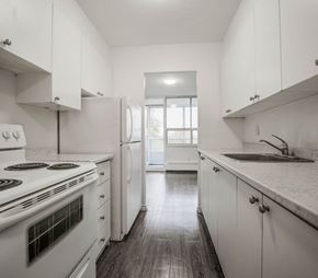 Hamilton apartment for rent - A kitchen with white cabinets and a stove top oven.