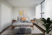Hamilton apartment for rent - A bedroom with a large bed and a plant.
