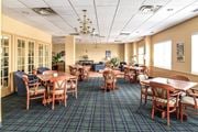 Hamilton apartment for rent - A large room with tables and chairs and a chandelier.