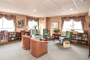 Hamilton apartment for rent - A library with multiple chairs and bookshelves.