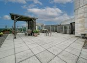 Hamilton apartment for rent - A patio with a table and chairs under a roof.