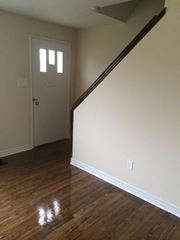 Cobourg apartment for rent - A room with a wooden floor and a white door.