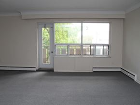 Hamilton apartment for rent - A room with a large window and a door.