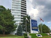 Hamilton apartment for rent - A tall white building with a sign that says "The Beverly Hills Apartments" in front of it.