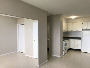 Hamilton apartment for rent - A kitchen with white appliances and cabinets is shown.