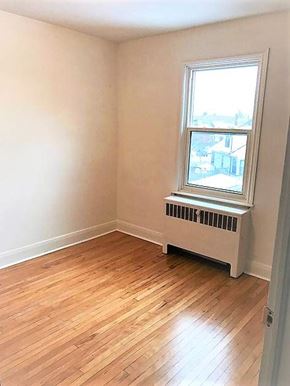 Kitchener apartment for rent - A room with a window and a radiator on the wall.