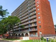 Hamilton apartment for rent - A red brick building with balconies and windows.
