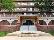 Hamilton apartment for rent - A building with a red brick wall and a black railing.