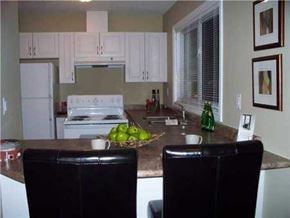 Hamilton apartment for rent - A kitchen with white cabinets and a granite countertop.