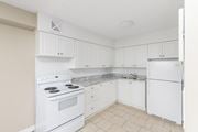 Hamilton apartment for rent - A white kitchen with a stove, sink, and refrigerator.
