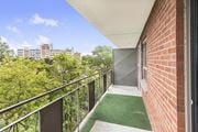 Stoney Creek apartment for rent - A balcony with a metal railing and a green carpet.
