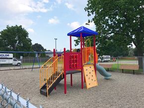 Hamilton apartment for rent - A playground with a red and yellow slide and a blue and yellow tower.